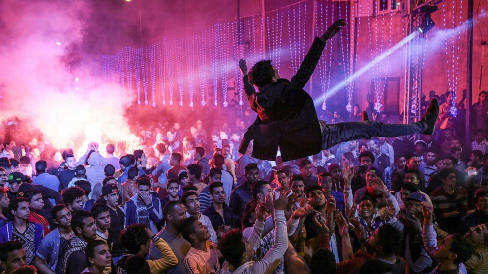PHOTO: In this Thursday, March 5, 2015 photo, youth dance at a local wedding in Salam City, a suburb on the outskirts of Cairo.