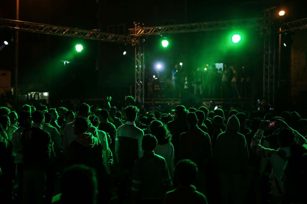 PHOTO: In this Thursday, March 5, 2015 photo, youth dance at a local wedding in Salam City, a suburb on the outskirts of Cairo.