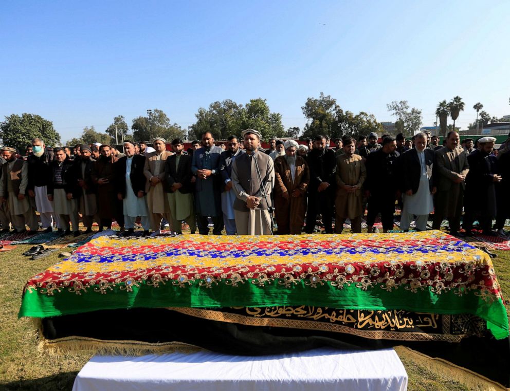 PHOTO: Afghan men pray near the coffin of journalist Malalai Maiwand, who was shot and killed by unknown gunmen in Jalalabad, Afghanistan, Dec. 10, 2020.