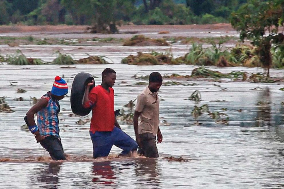 PHOTO: People walk on a road swept by flooding waters after tropical storm Ana in Chikwawa, Malawi, Jan. 25, 2022.