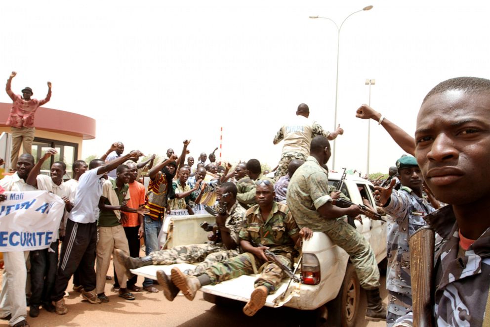 PHOTO: Supporters of Mali's junta participate in a demonstration against regional bloc ECOWAS (Economic Community of West African States) at the international airport of Bamako, March 29, 2012. 