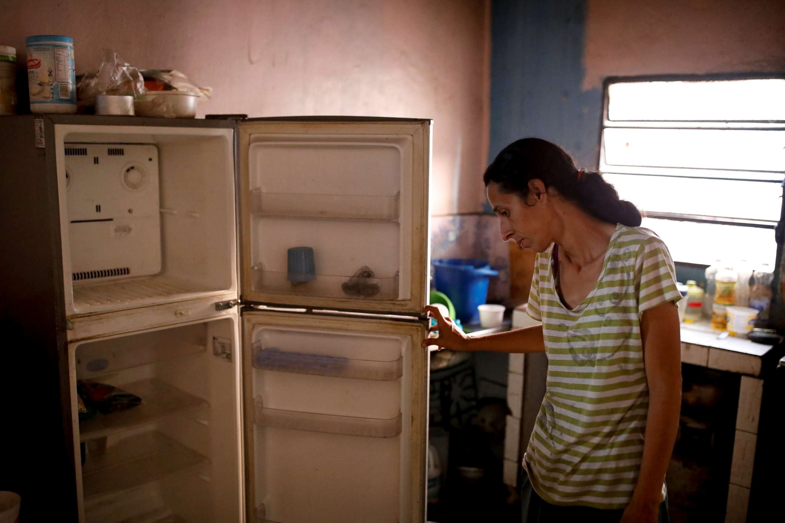 PHOTO: Yaneidi Guzman, 38, shows the food she has in her kitchen at home in Caracas, Venezuela, Feb. 19, 2019.