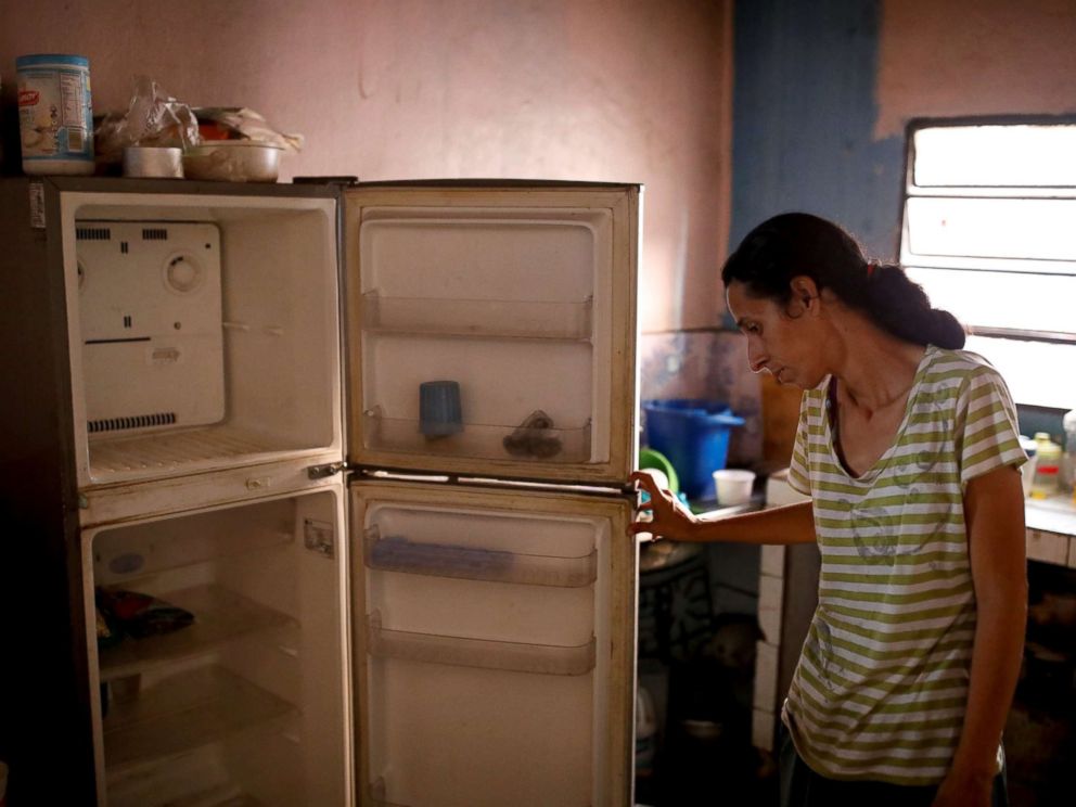 PHOTO: Yaneidi Guzman, 38, shows the food she has in her kitchen at home in Caracas, Venezuela, Feb. 19, 2019.