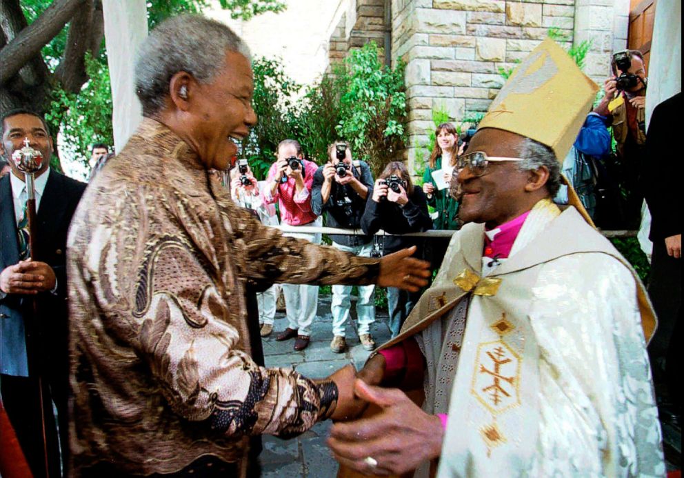 PHOTO: FILE - Retiring Archbishop of Cape Town Desmond Tutu, right, greets President Nelson Mandela at a service in Cape Town, Sunday June 23, 1996 held to celebrate the end of Tutu's tenure as leader of the Anglican Church in South Africa.