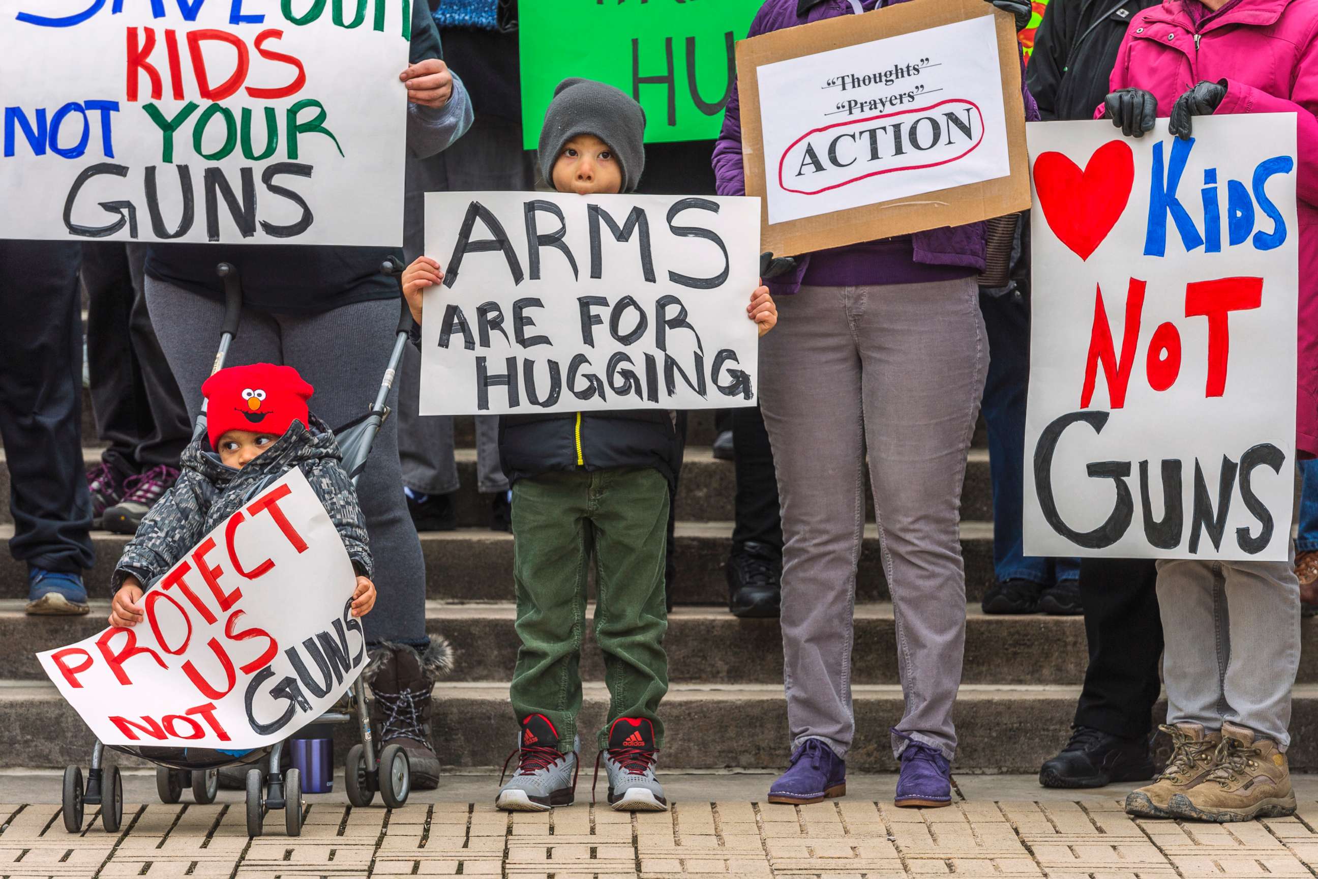 PHOTO: Kanawha City Elementary school student Derrick Johnson, 5, and his brother David Johnson, 3 stand with others gathered on the steps of the Capitol building in Charleston, W.V., March 24, 2018.