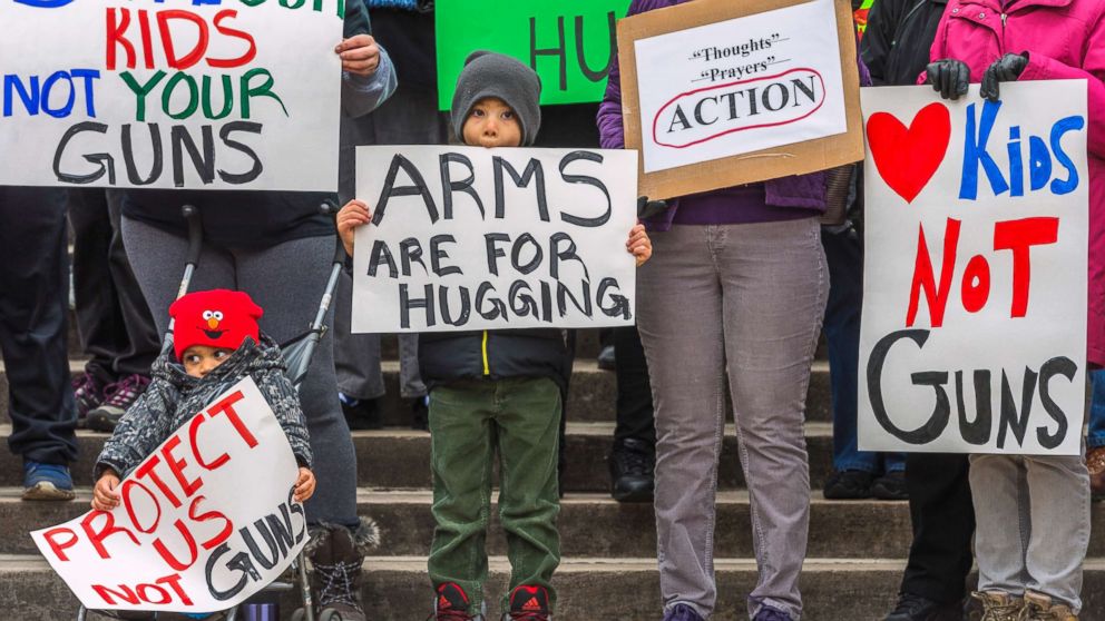 PHOTO: Kanawha City Elementary school student Derrick Johnson, 5, and his brother David Johnson, 3 stand with others gathered on the steps of the Capitol building in Charleston, W.V., March 24, 2018.