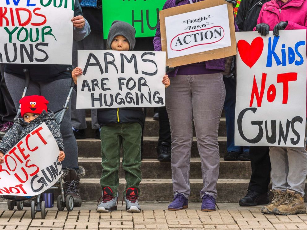 PHOTO: Kanawha City Elementary school student Derrick Johnson, 5, and his brother David Johnson, 3 stand with others gathered on the steps of the Capitol building in Charleston, W.V., March 24, 2018.