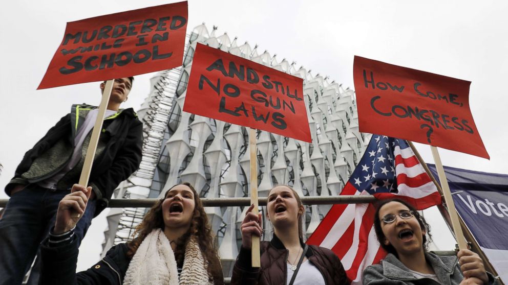 PHOTO: Protesters carry placards and shout slogans during a demonstration calling for greater gun control, outside the U.S. Embassy in south London, March 24, 2018.