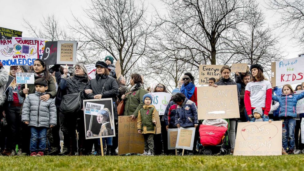 PHOTO: Demonstrators hold signs during a rally calling for stronger gun control in the United States at the Museumsquare in the center of Amsterdam, March 24, 2018.