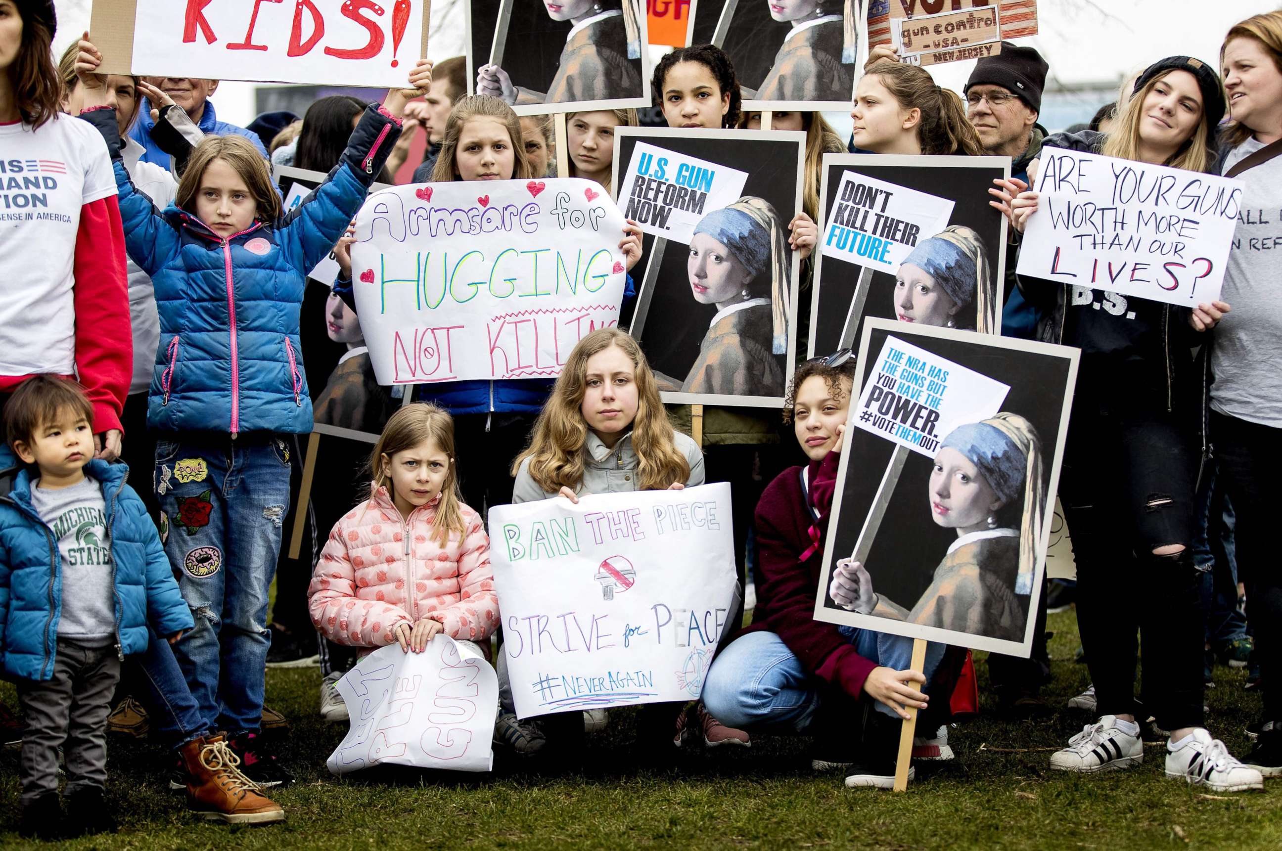 PHOTO: Demonstrators hold signs during a rally calling for stronger gun control in the United States at the Museum Square in Amsterdam, March 24, 2018. 