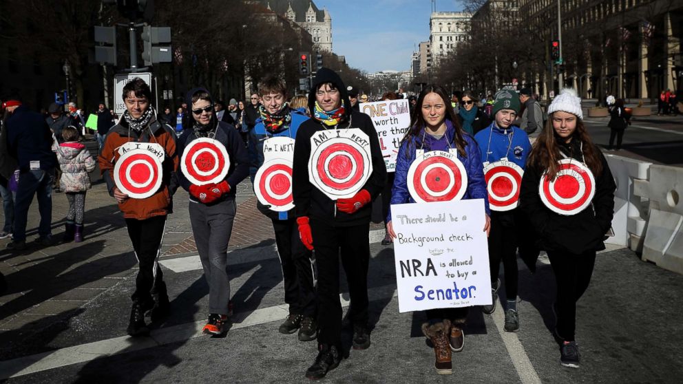 PHOTO: Students from Centreville, Virginia wear targets on their chests as they arrive for the March for Our Lives rally, March 24, 2018 in Washington, D.C. 