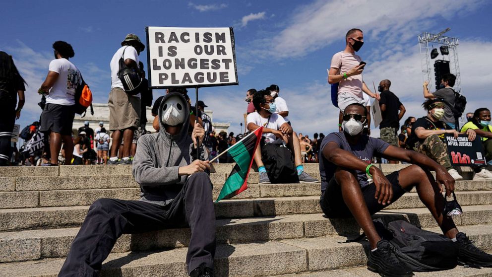 PHOTO: People attend the March on Washington, Aug. 28, 2020, in Washington on the 57th anniversary of the Rev. Martin Luther King Jr.'s "I Have A Dream" speech.