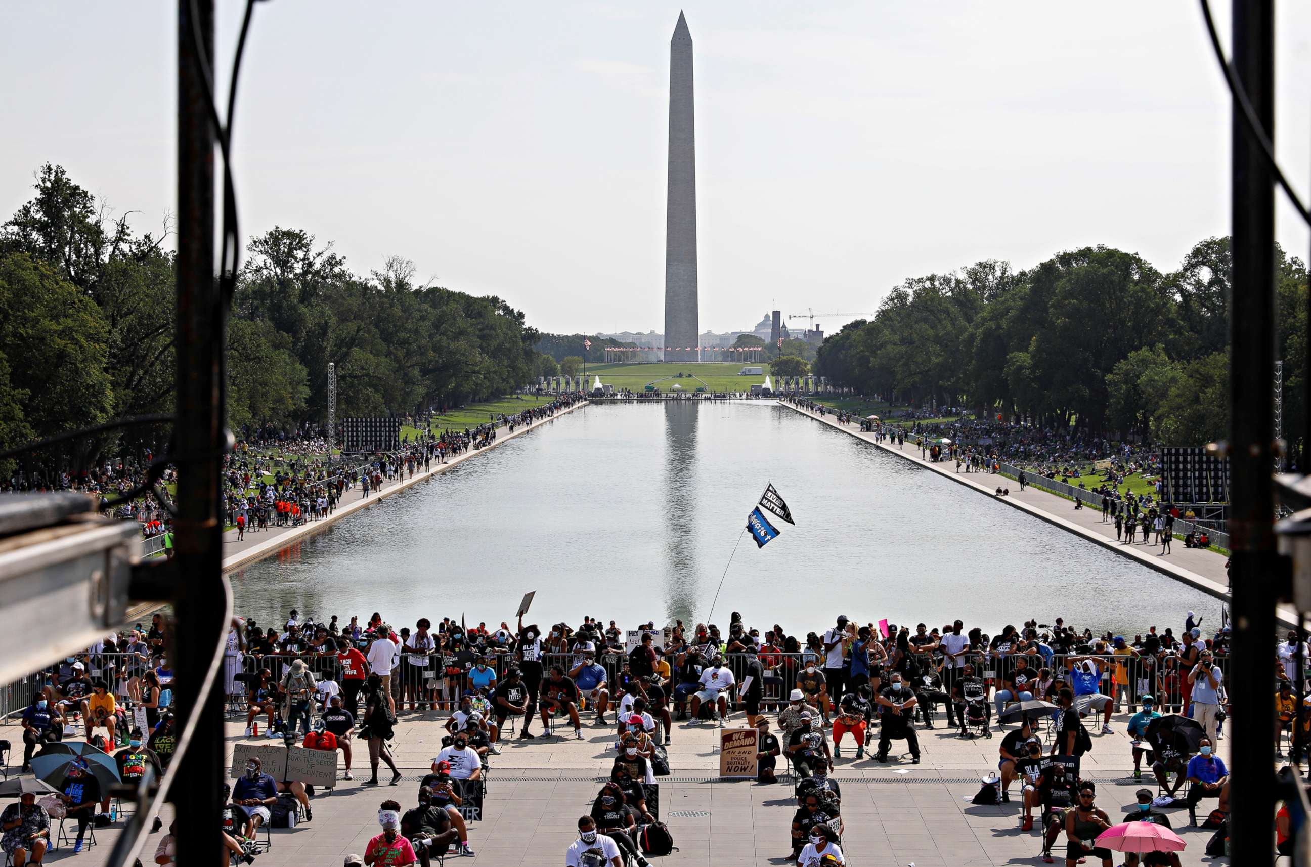 PHOTO: Demonstrators sit in socially distanced chairs at the Lincoln Memorial as thousands more begin to gather along the sides of the Lincoln Memorial reflecting pool for the March on Washington, Aug. 28, 2020.