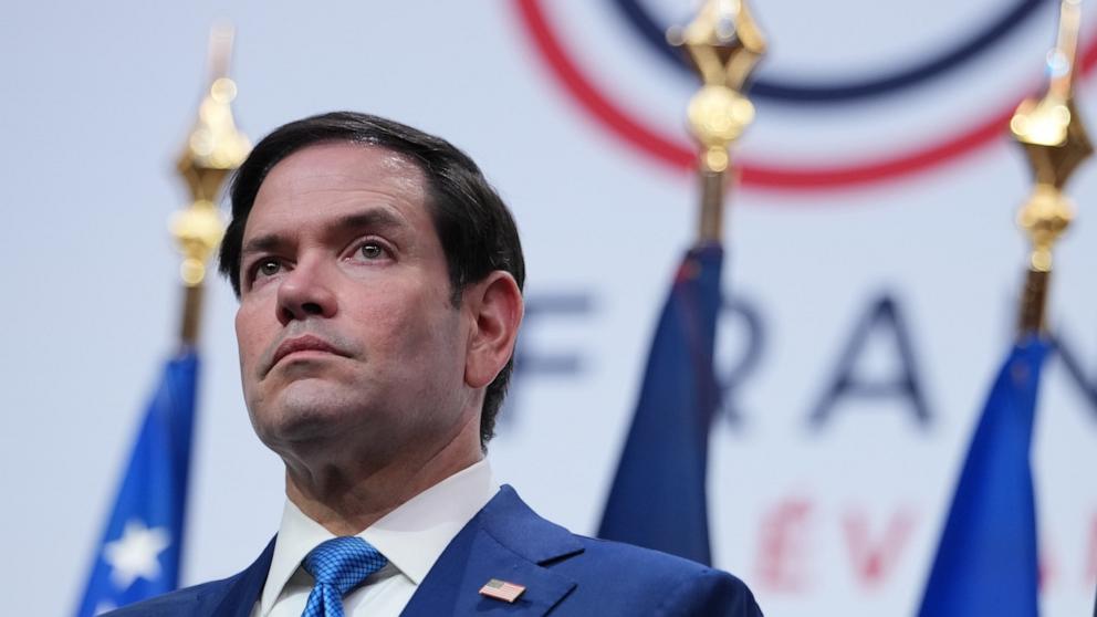 PHOTO: Secretary of State, Marco Rubio listens as President Donald Trump speaks during a news conference at the G7 summit, June 17, 2026, in Evian-les-Bains, France.