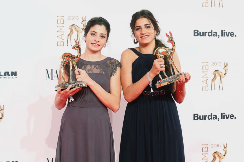 PHOTO: Yusra Mardini and Sara Mardini pose with award at the Bambi Awards 2016 winners board at Stage Theater, Nov. 17, 2016, in Berlin. 