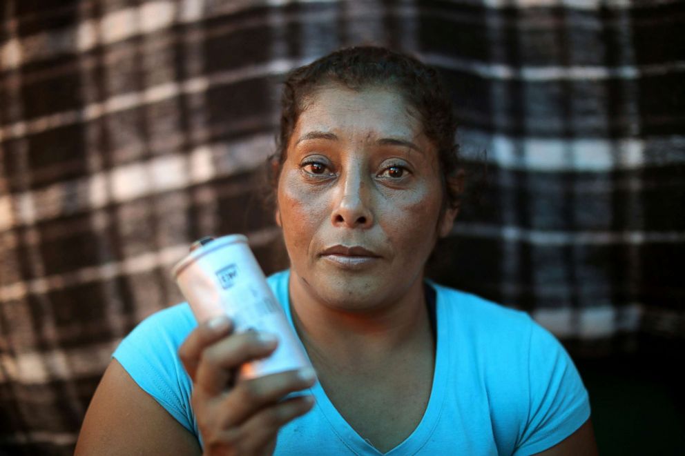 PHOTO: Maria Meza poses for a photo with a tear gas canister that she picked up as she sits in her tent at a temporary shelter in Tijuana, Mexico, Nov. 26, 2018.