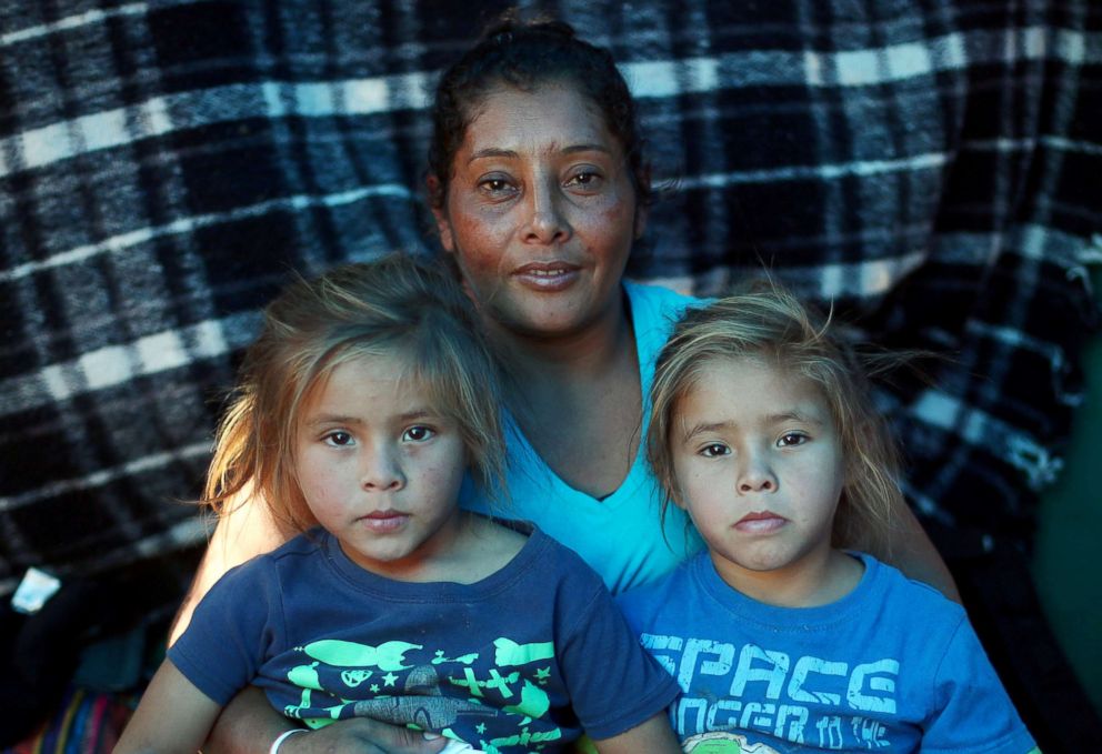 PHOTO: Maria Meza sits with her five-year-old twin daughters Cheili Mejia Meza and Saira Mejia Meza inside their tent in a temporary shelter in Tijuana, Mexico, Nov. 26, 2018.