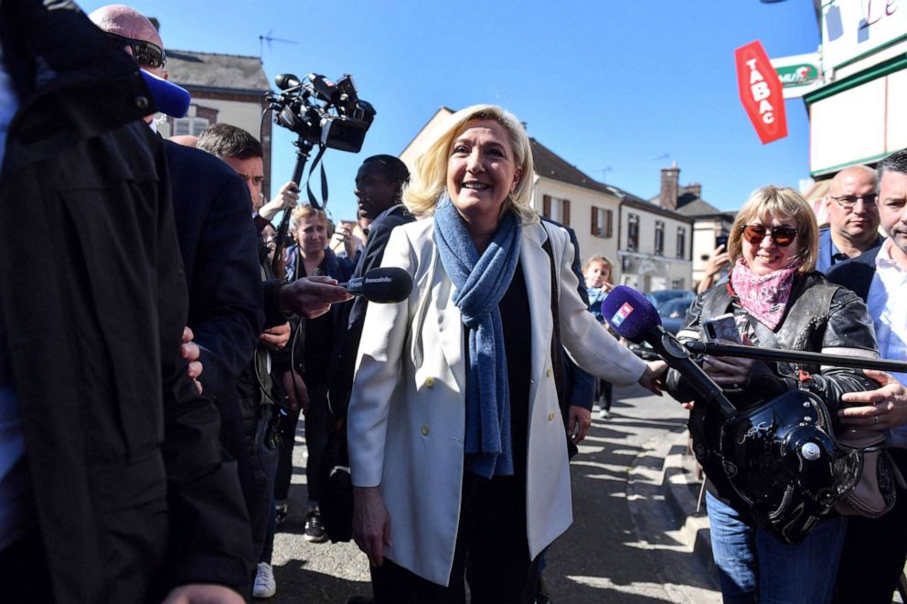 PHOTO: French presidential candidate Marine Le Pen is surrounded by the press during a campaign visit to Saint-Remy-sur-Avre, northwestern France, on April 16, 2022, ahead of the second round of France's presidential election. 