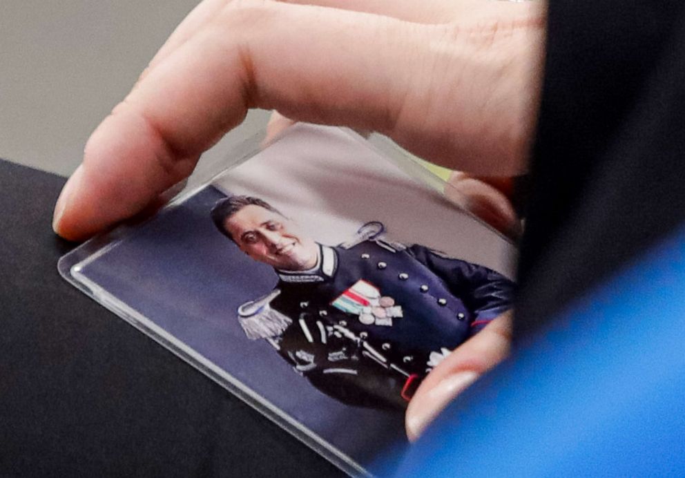 PHOTO: Rosa Maria Esilio holds a photograph of her late husband, Italian police officer Mario Cerciello Rega, in a courtroom in Rome, Italy, on Sept. 9, 2020, ahead of a hearing for the trial in which two American tourists are accused of his murder.