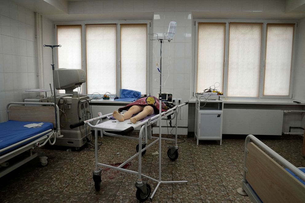 PHOTO: The lifeless body of a girl killed during shelling in a residential area lies on a gurney at the city hospital of Mariupol in eastern Ukraine, Feb. 27, 2022.