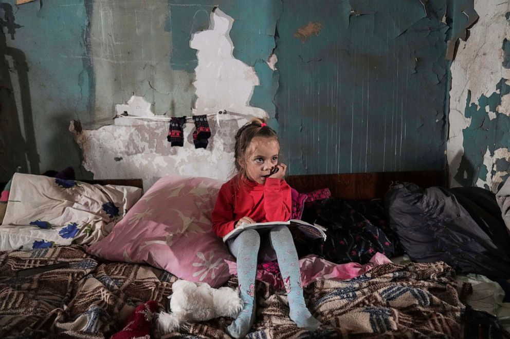 PHOTO: A girl sits in the improvised bomb shelter in Mariupol, Ukraine, March 7, 2022.