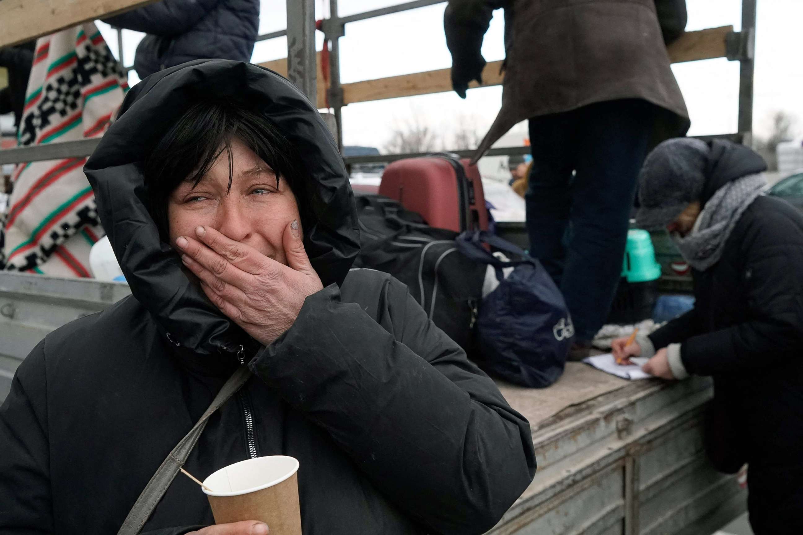 PHOTO: Evacuees from Mariupol arrive at the car park of a shopping center on the outskirts of the city of Zaporizhzhia, which is now a registration center for displaced people, March 16, 2022.