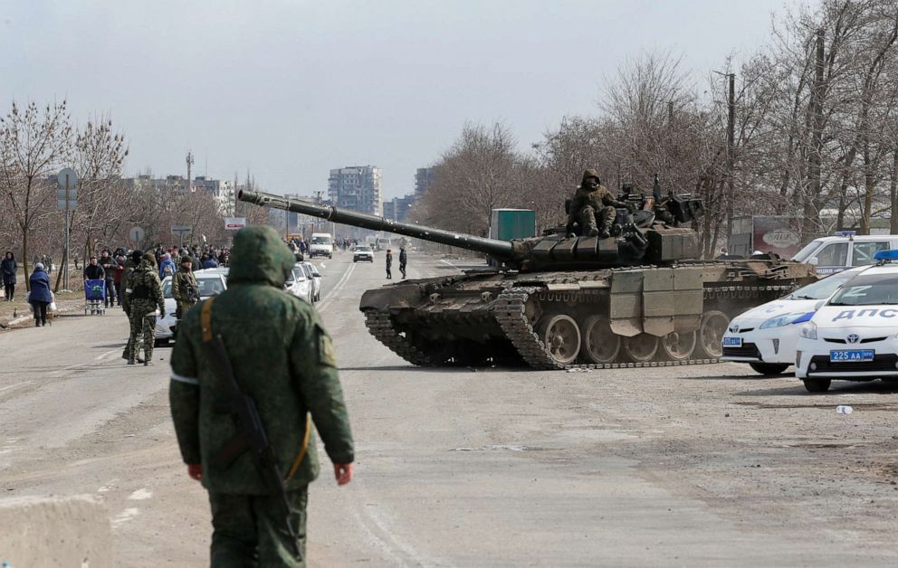PHOTO: Service members of pro-Russian troops are seen atop of a tank during Ukraine-Russia conflict on the outskirts of the besieged southern port city of Mariupol, Ukraine March 20, 2022.