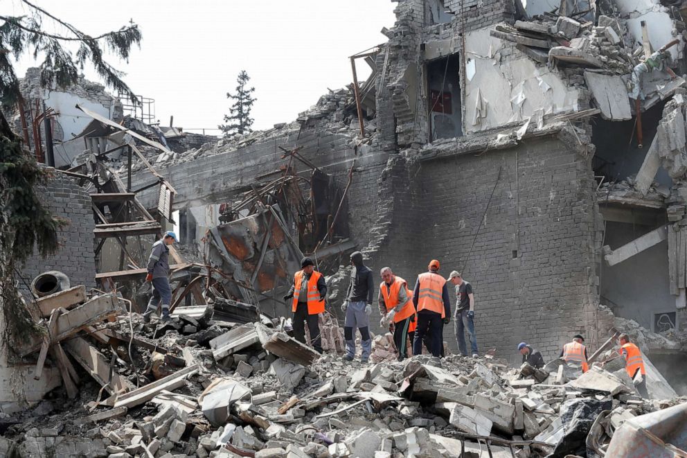 FILE PHOTO: Emergency management specialists and volunteers remove debris of the Donetsk Academic Regional Drama Theater, destroyed in the course of Russia's war on Ukraine, in port city of Mariupol, southeastern Ukraine, April 25, 2022.