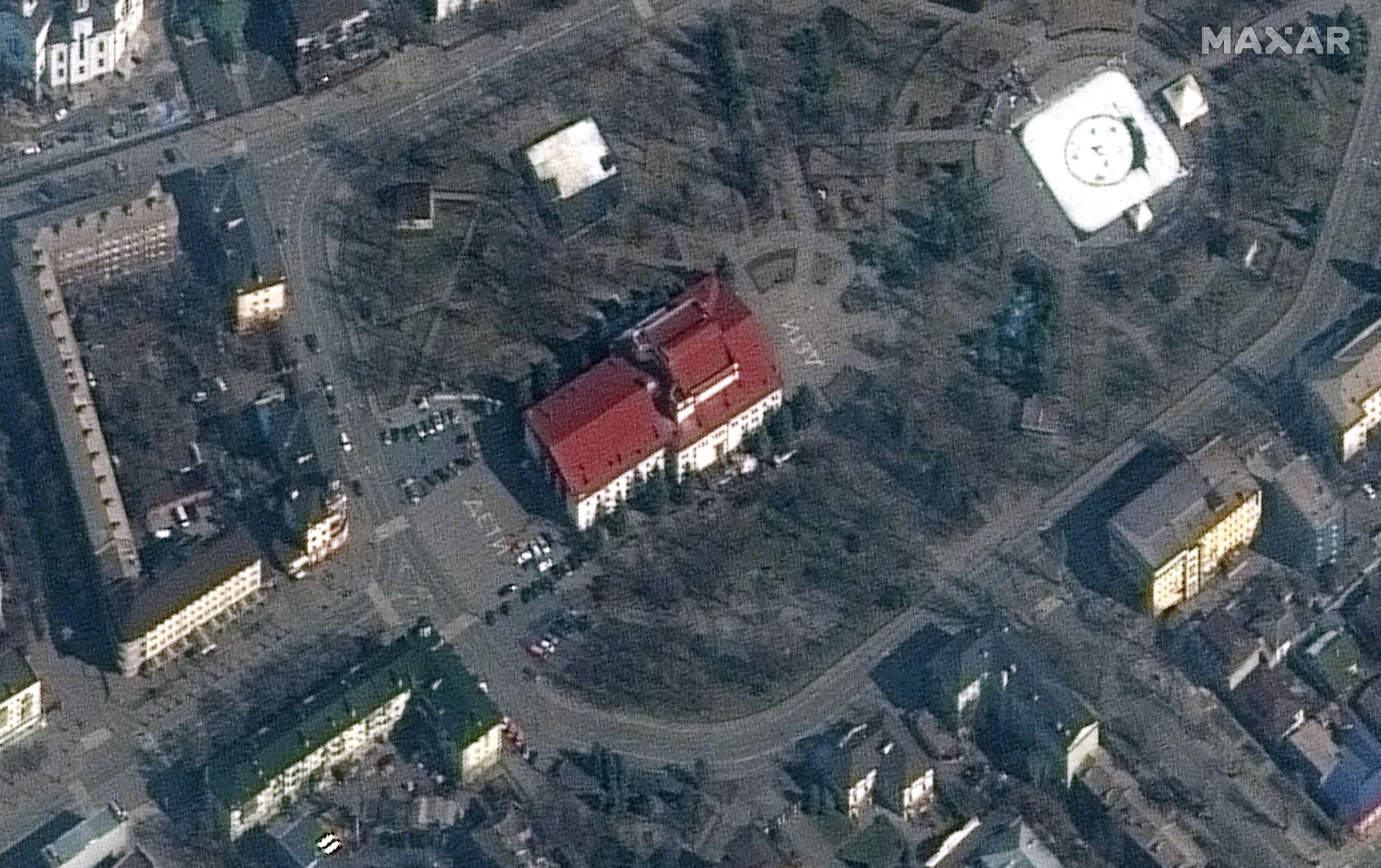 PHOTO: A satellite image shows the Mariupol Drama Theatre before being bombing, with the word "children" in Russian written in large white letters on the pavement in front of and behind the building, in Mariupol, Ukraine, March 14, 2022.