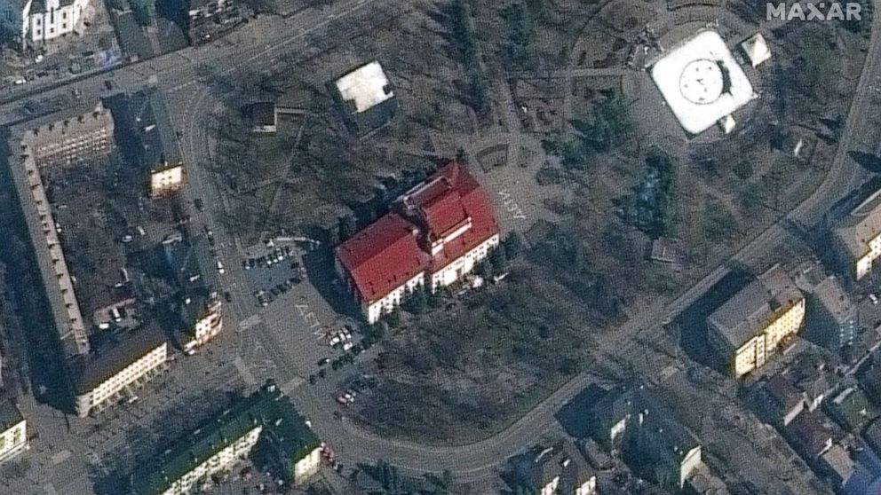 PHOTO: A satellite image shows the Mariupol Drama Theatre before being bombing, with the word "children" in Russian written in large white letters on the pavement in front of and behind the building, in Mariupol, Ukraine, March 14, 2022.