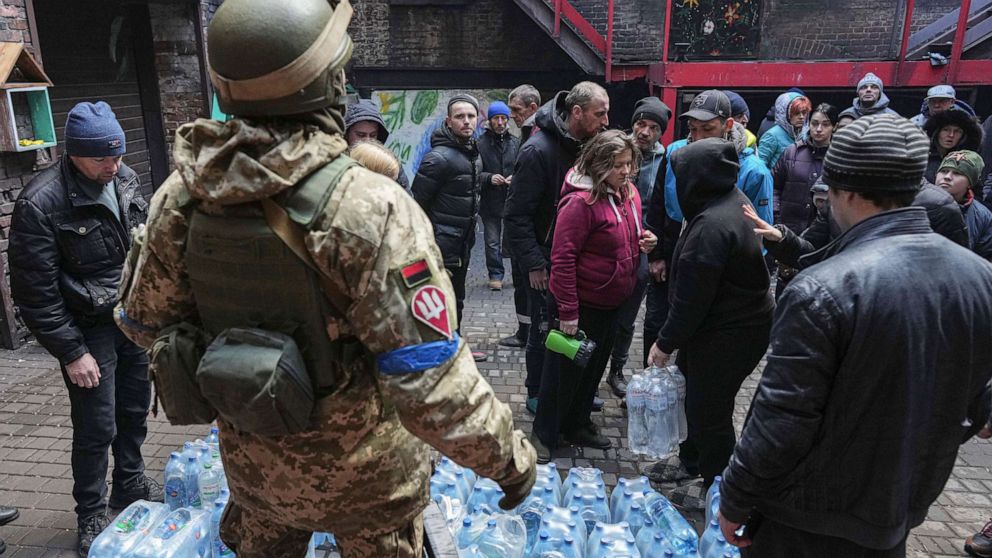 PHOTO: Ukrainian servicemen distribute water to people in Mariupol, Ukraine, March 6, 2022.
