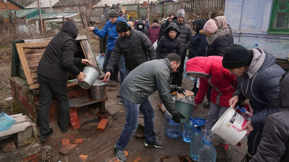 PHOTO: People line up to get water at the well in outskirts of Mariupol, Ukraine, March 9, 2022.