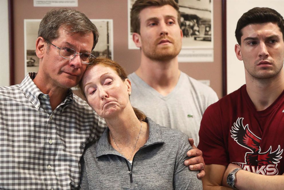 PHOTO: Parents John and Lisa Dombroski, left, stand with their sons John, at rear, and Kevin during a press conference regarding their missing son and brother Mark, at the Hamilton Police Station in Hamilton, Bermuda, March 19, 2018. 