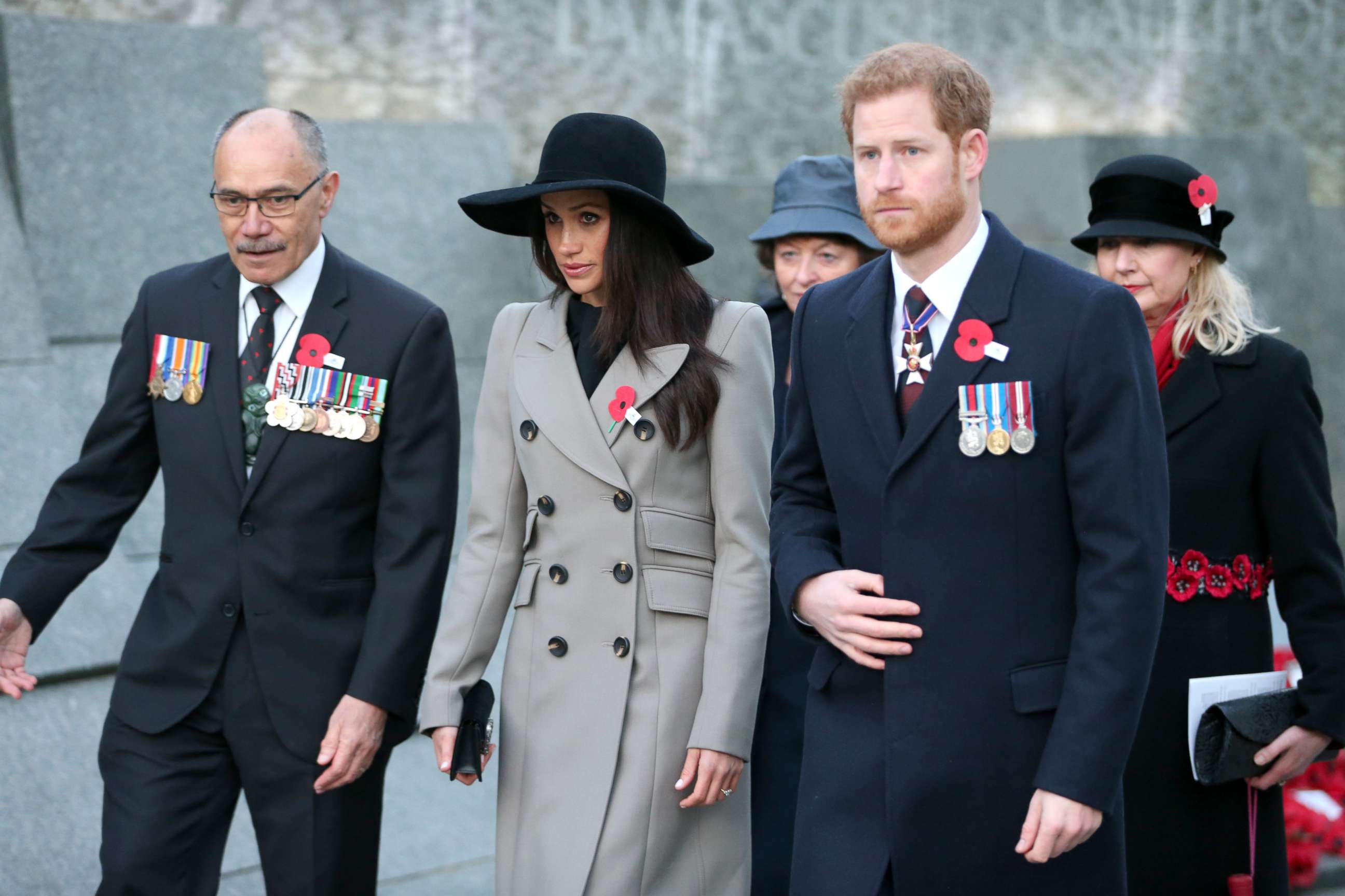 PHOTO: Prince Harry (2R) and Meghan Markle attend an Anzac Day dawn service at Hyde Park Corner, April 25, 2018, in London. 