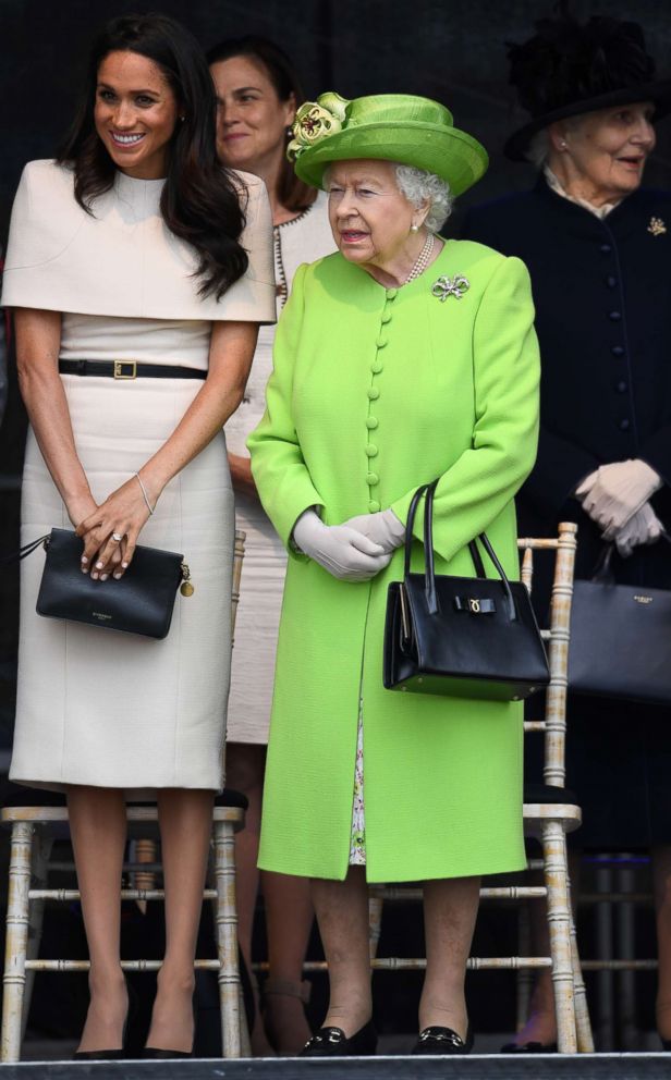 PHOTO: Queen Elizabeth II stands with Meghan, Duchess of Sussex during a ceremony to open the new Mersey Gateway Bridge, June 14, 2018, in the town of Widnes in Halton, Cheshire, England.