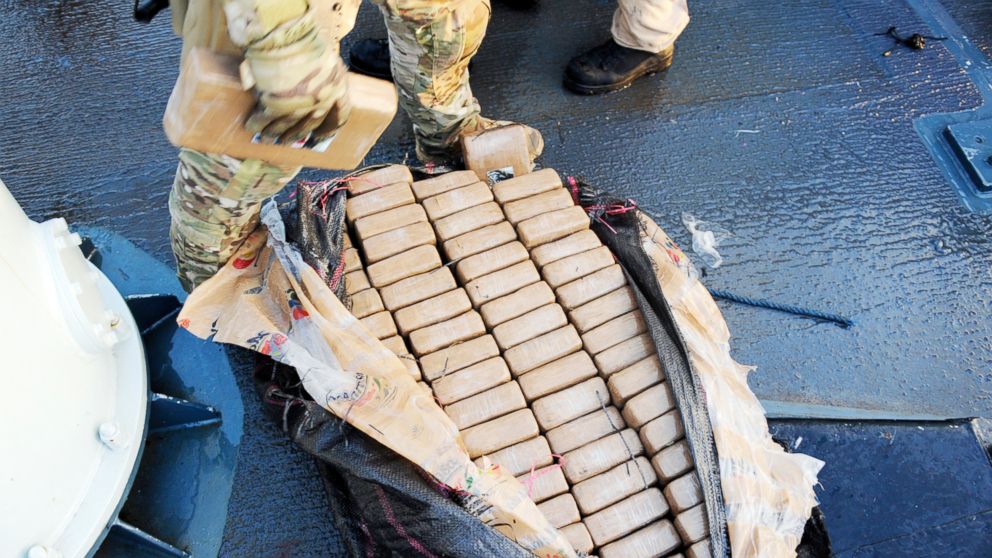 A member of the United States Coast Guard removes a 1 kg package of cocaine for testing on HMCS Whitehorse, part of the roughly 3,000 pounds of cocaine seized on April 5, 2018, during Operation CARIBBE.