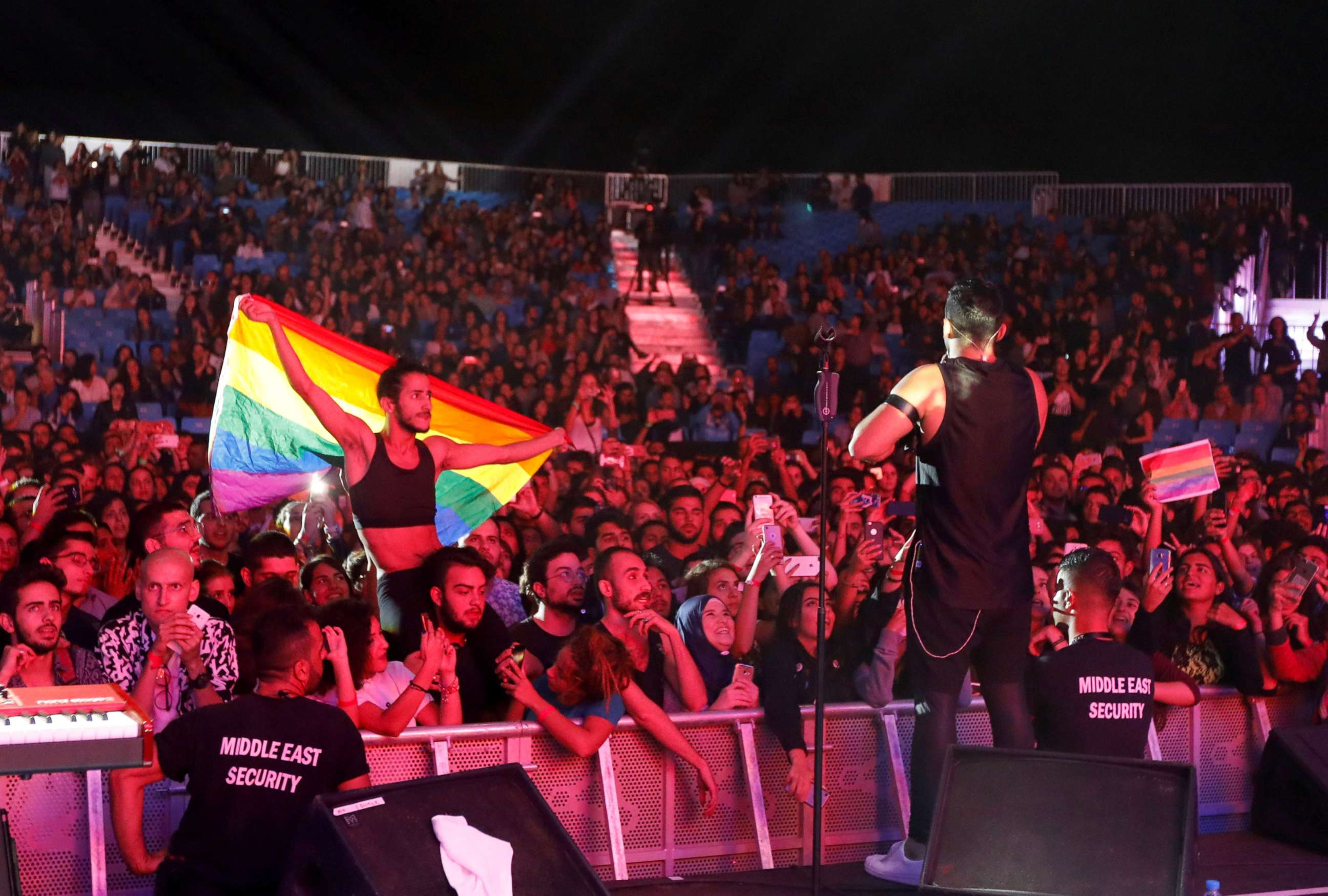 PHOTO: A fan of Lebanese alternative rock band Mashrou' Leila holds a rainbow flag during their concert at the Ehdeniyat International Festival in Ehden town, Lebanon, Aug. 12, 2017.