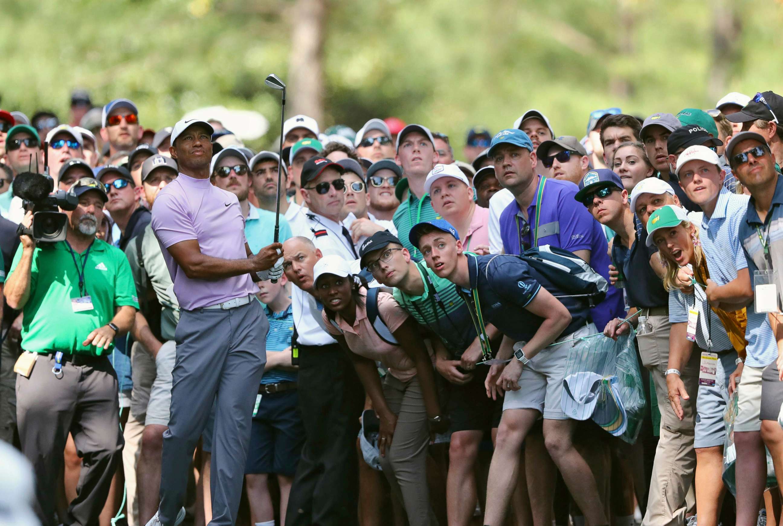 PHOTO: In this April 13, 2019, file photo, Tiger Woods hits from the gallery along the 11th fairway during the third round of the Masters golf tournament at Augusta National in Augusta, Ga.
