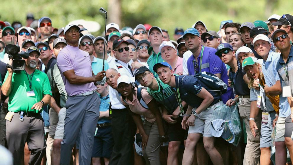 PHOTO: In this April 13, 2019, file photo, Tiger Woods hits from the gallery along the 11th fairway during the third round of the Masters golf tournament at Augusta National in Augusta, Ga.