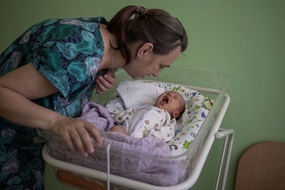 PHOTO: Elena, 36, checks on her baby Mikhail inside Pokrovsk maternity hospital, Donetsk region, eastern Ukraine, June 28, 2022.