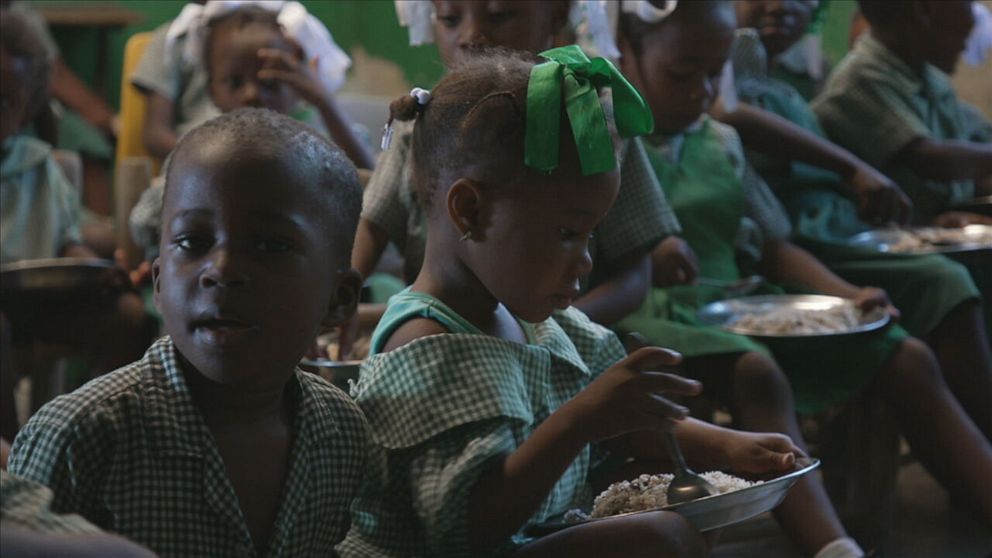 PHOTO: Haitian schoolchildren eat rice and beans.