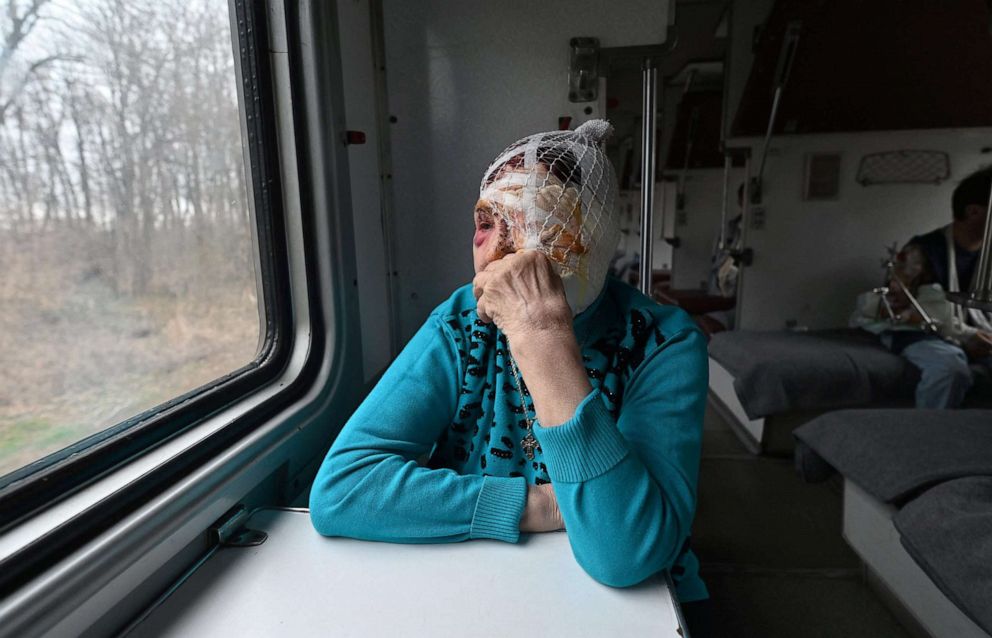 PHOTO: Praskovya, 77, watches out of a window of a medical evacuation train on its way to the western Ukrainian city of Lviv, April 10, 2022. 