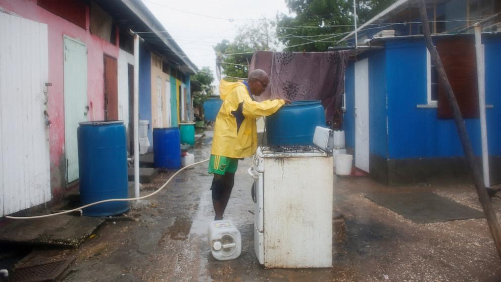 PHOTO: Douglas Butler, a retired fisherman, fills up a barrel of water for his household as Hurricane Melissa approaches, in Port Royal, Jamaica, October 27, 2025.  