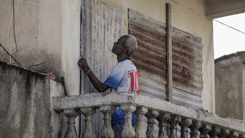 PHOTO: A man covers the windows of his home with corrugated metal ahead of the arrival of Hurricane Melissa in Santiago de Cuba, Cuba, October 27, 2025.