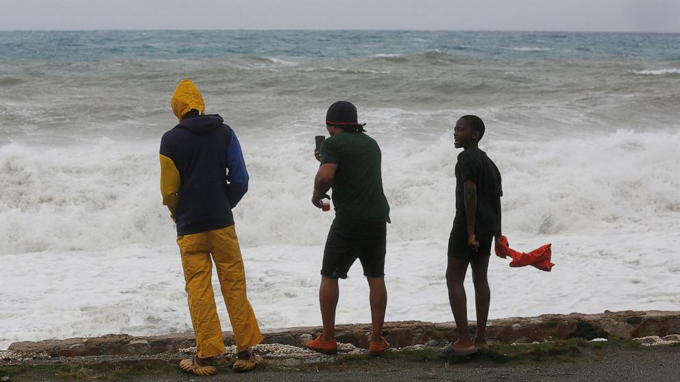 PHOTO: People watch waves crash, as Hurricane Melissa approaches, in the Harbour View neighborhood of Kingston, Jamaica, October 27, 2025. 