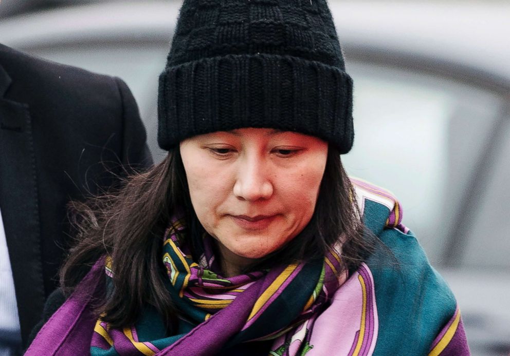 PHOTO: Huawei chief financial officer Meng Wanzhou arrives at a parole office with a security guard in Vancouver, British Columbia, Dec. 12, 2018.