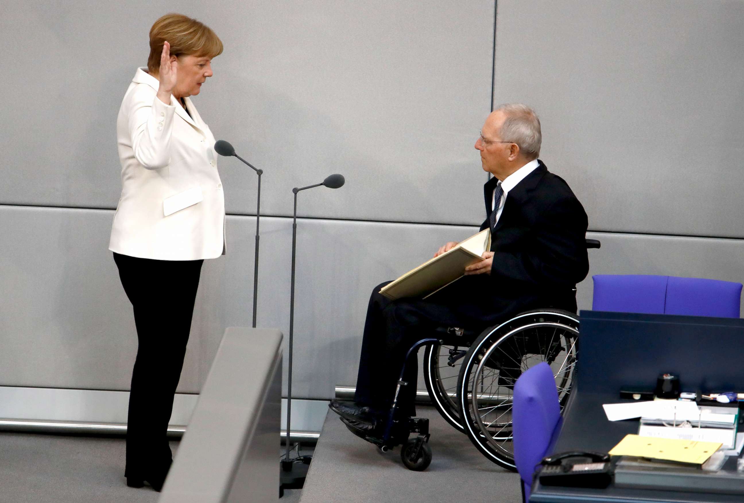 PHOTO: Wolfgang Schaeuble, the president of the Bundestag administers the oath of office to German Chancellor Angela Merkel in Berlin, March 14, 2018.
