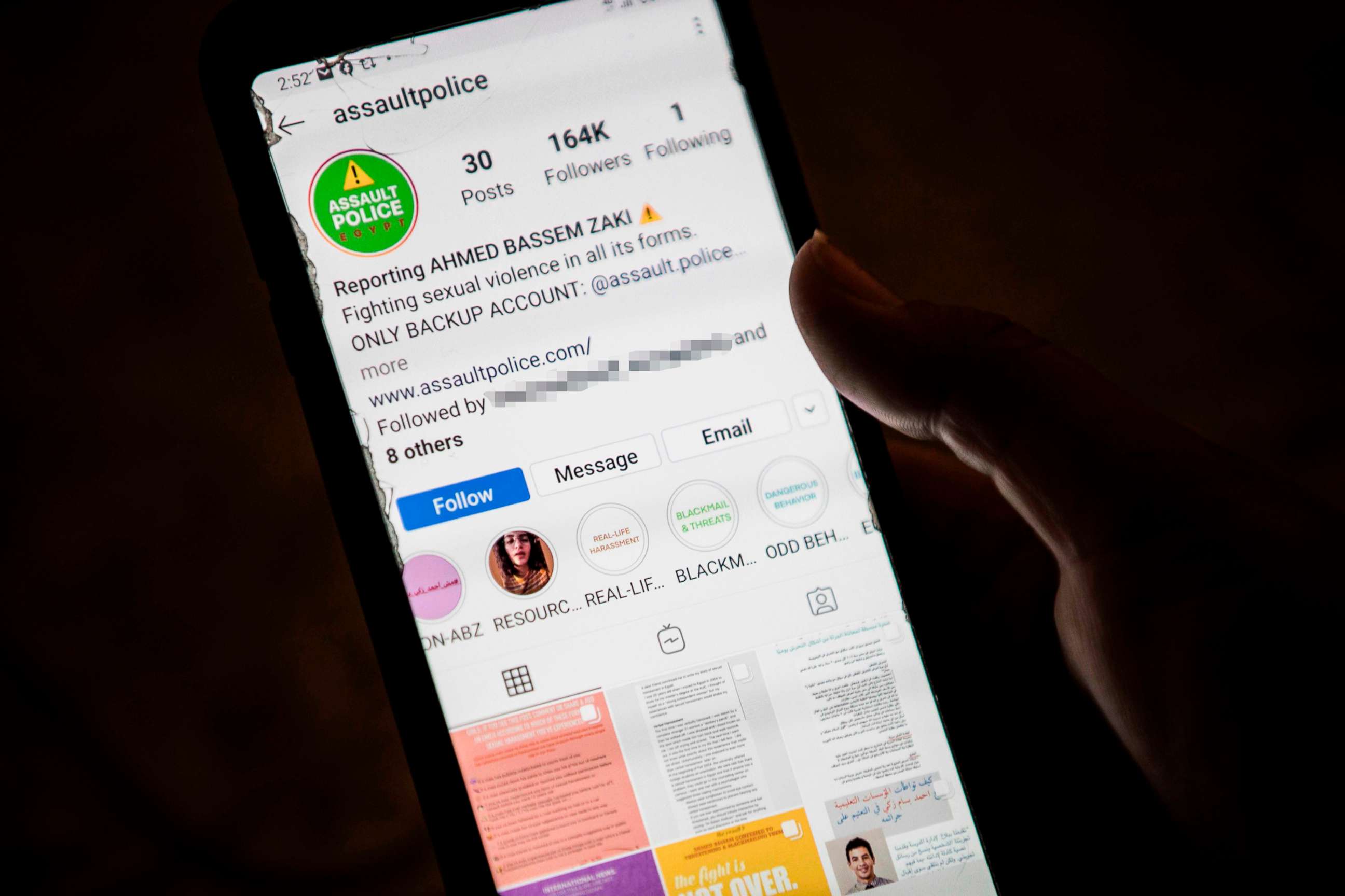 PHOTO: A woman checks on her phone an Instagram account for reporting allegations of sexual harassment and misconduct against Ahmed Bassam Zaki, a 22-year-old student, in Cairo, July 15, 2020. 