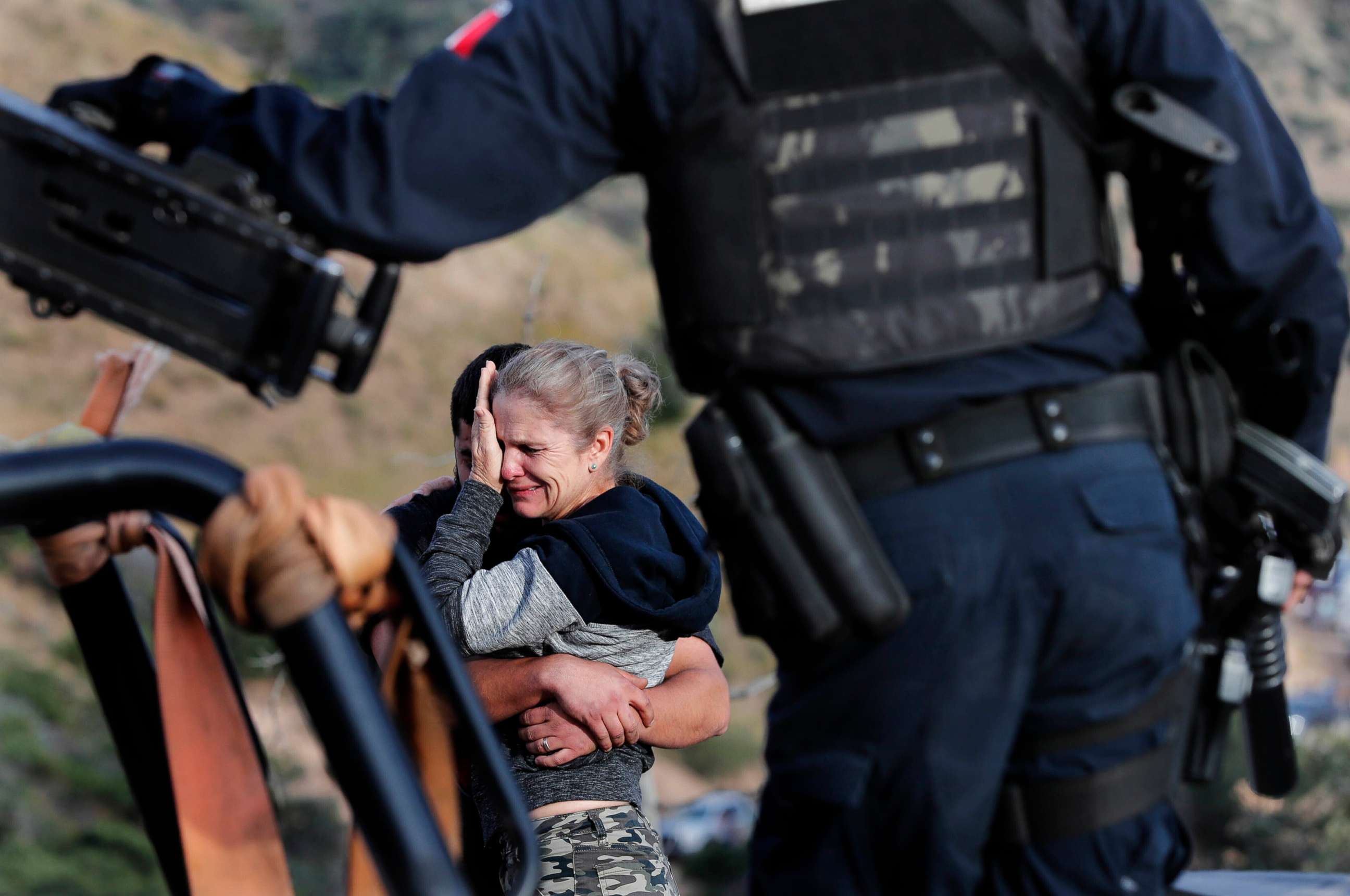 PHOTO: Framed by heavily armed Mexican authorities, relatives of the LeBaron family mourn at the site where nine U.S. citizens, were killed, at the Sonora-Chihuahua border, Mexico, Nov 6, 2019. 