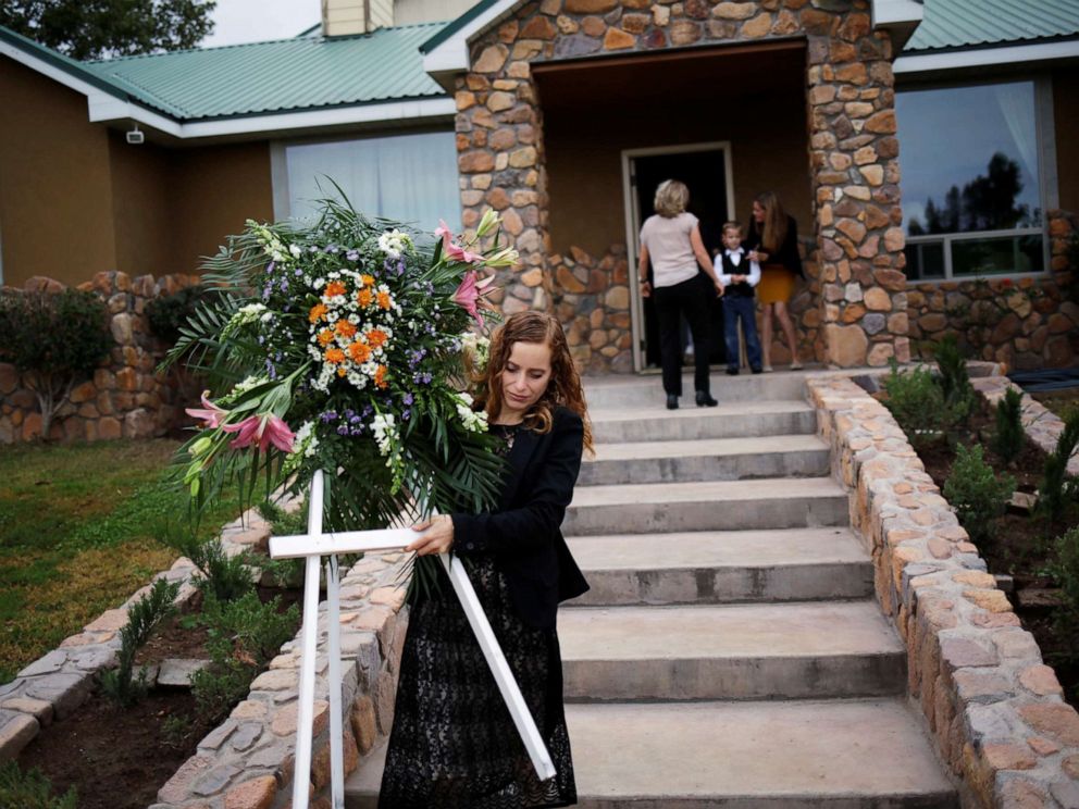 PHOTO: A relative carries a wreath before the funeral of Dawna Ray Langford and her two children, members of the Mexican-American Mormon community killed by unknown assailants, in La Mora, Sonora state, Mexico, Nov. 7, 2019.